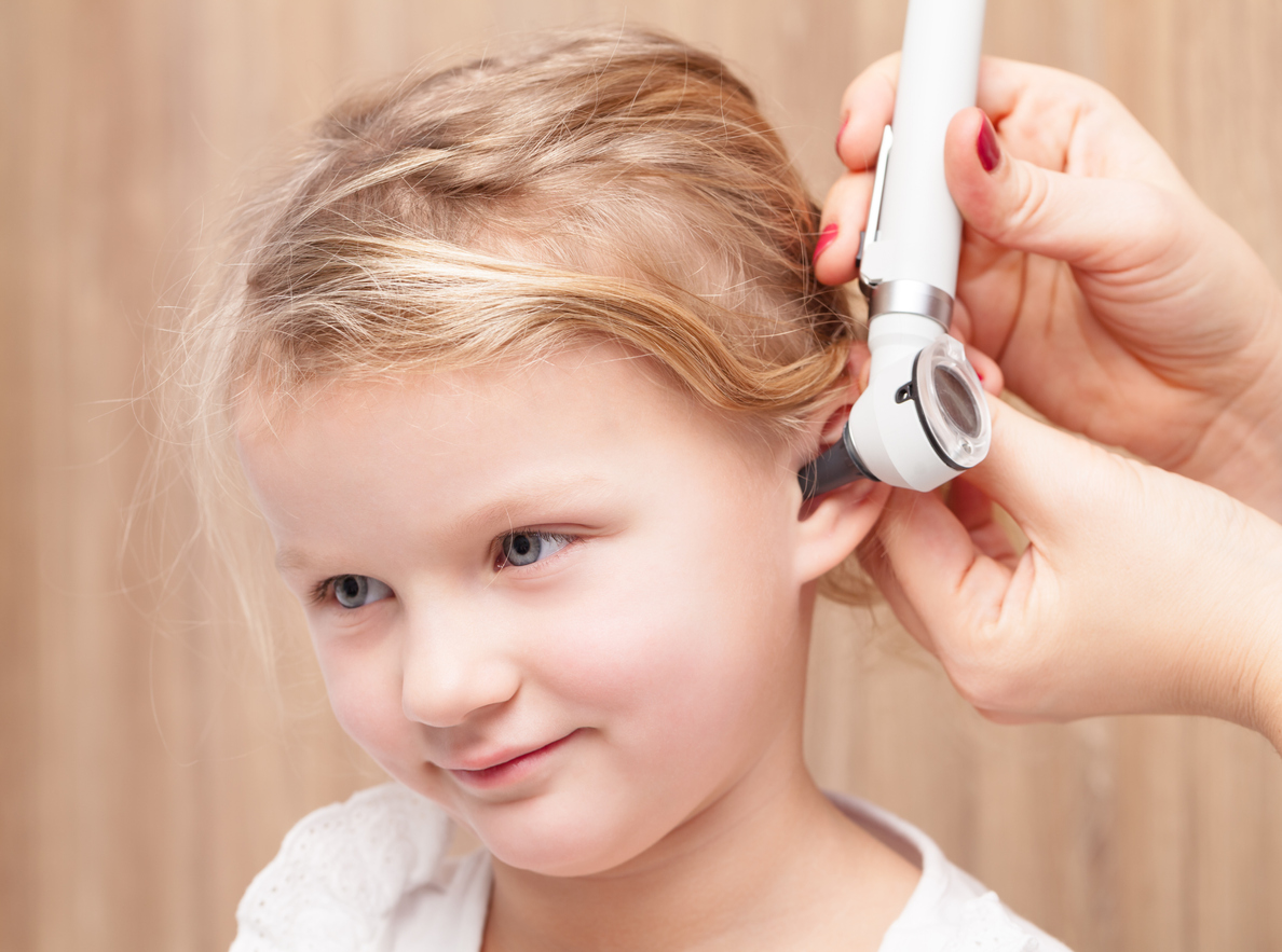 Child ENT check - doctor examining ear of a little girl with otoscope