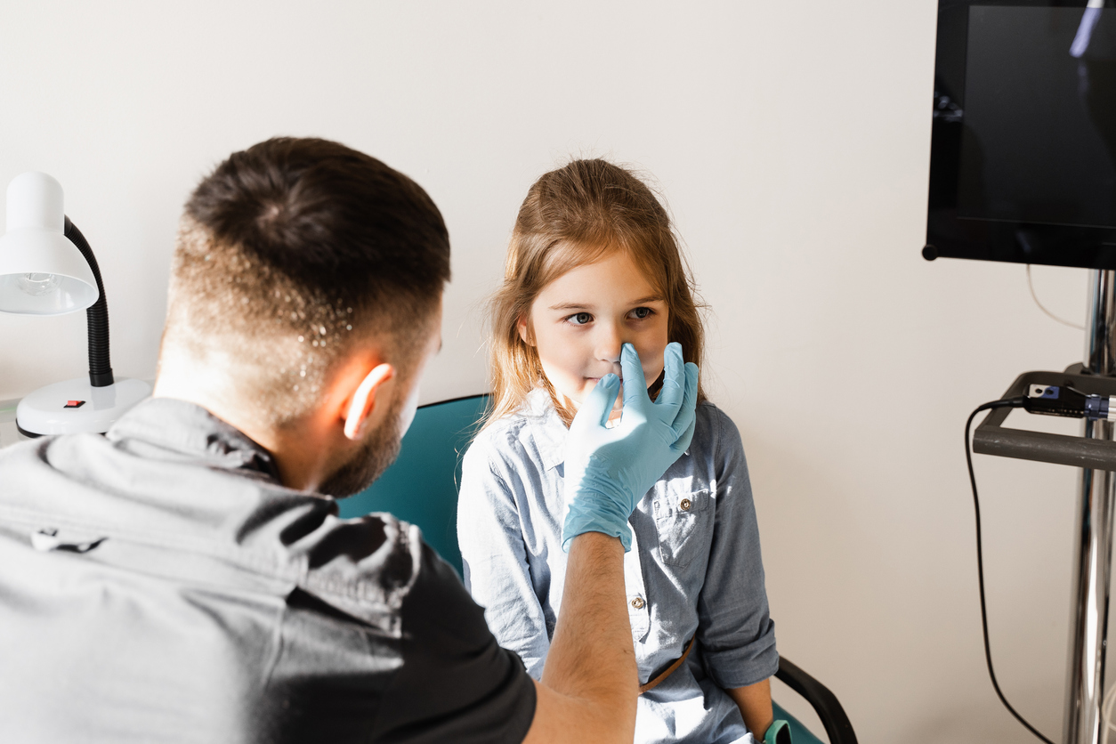 Nose examination of the child. Consultation of kid with a pediatric otolaryngologist in a medical clinic.